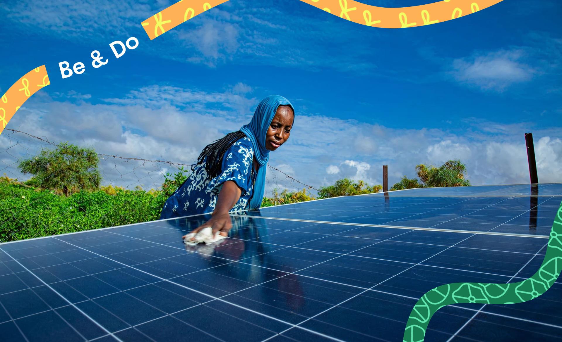 Mauritanian woman cleaning the solar panels that provide power for her cooperative's water supply